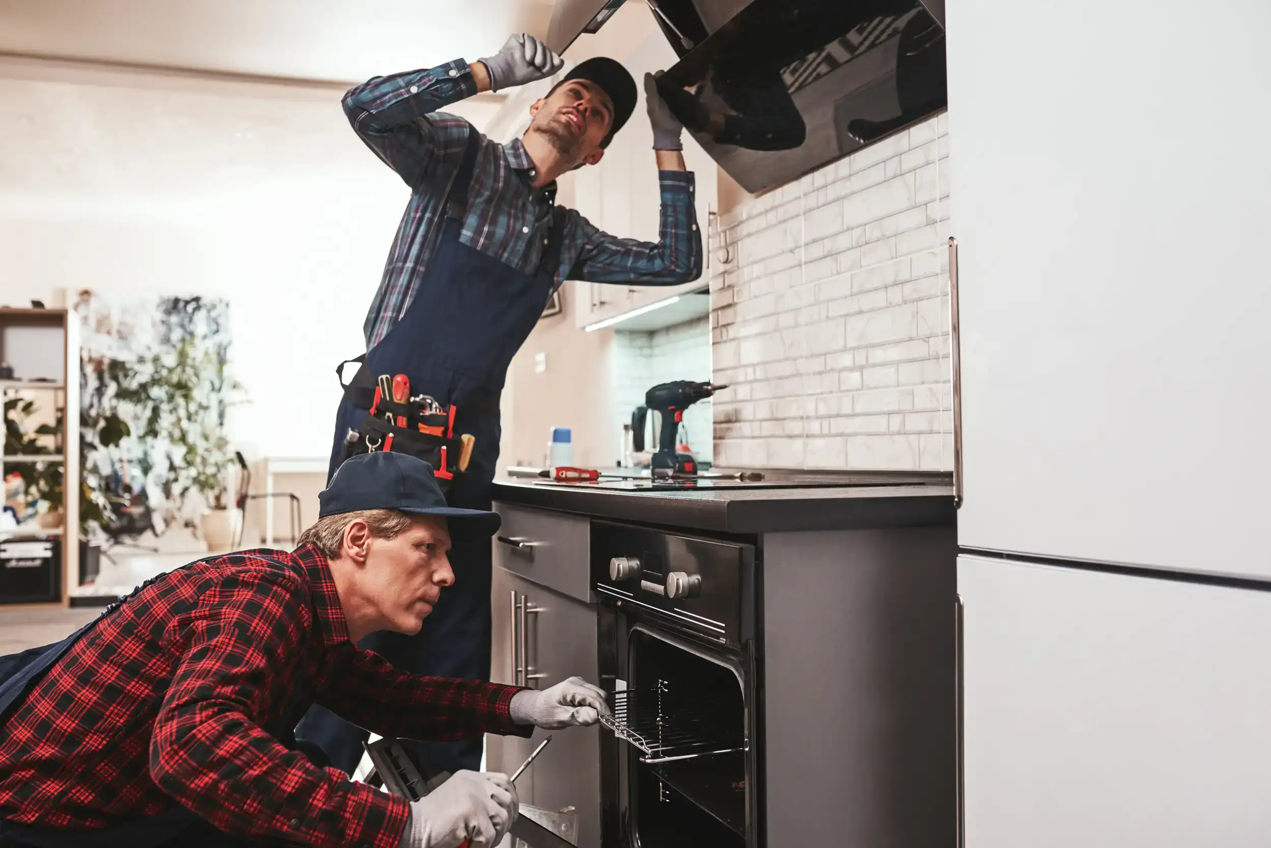 Two handyman working on installing the stove.